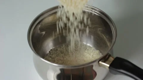 Pouring rice into a pan Stock Footage 66753688