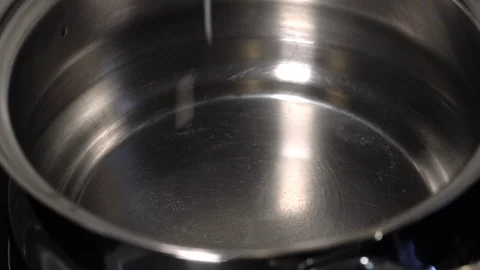 Pouring rice into a pot of water Stock Footage 125557307