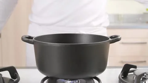Pouring rice into a saucepan Stock Footage 24663777