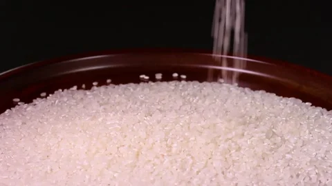 Pouring rice on a tray Stock Footage 315920270