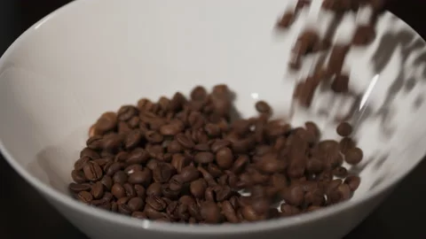 Pouring roasted brown coffee beans on white isolated background with small Stock Footage 140222354