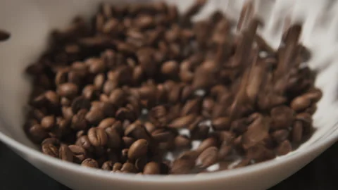 Pouring roasted brown coffee beans on white isolated background with small Stock Footage 140222484