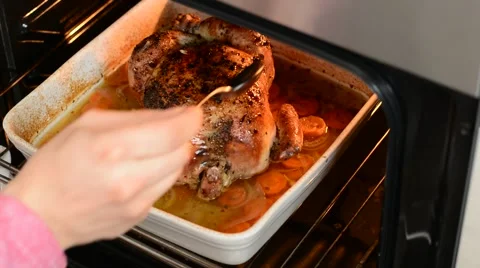 Pouring on roasted chicken. Stock Footage 53746901