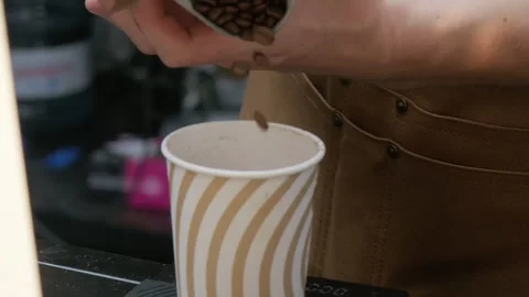 Pouring roasted coffee beans into the cup for measuring Stock Footage 263626973