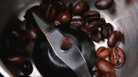 Pouring roasted coffee beans into an electric coffee grinder machine Stock Footage 170149786