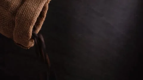 Pouring roasted coffee beans from sack isolated dark background Stock Footage 273682704