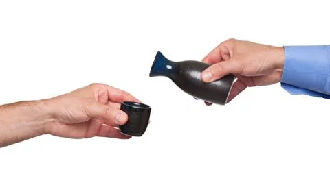 Pouring sake from its bottle Stock Photos