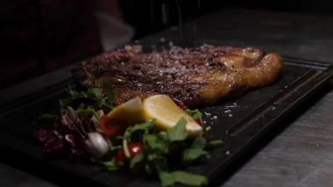 Pouring salt on the meat 動画素材 229937575