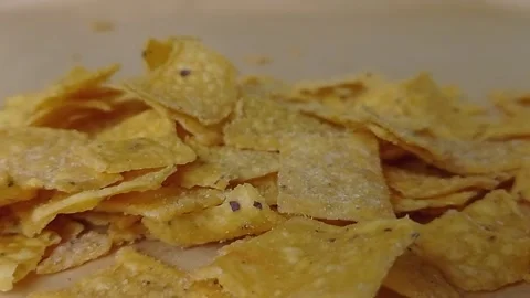 Pouring the salted nachos into the table  Stock Footage 151027626