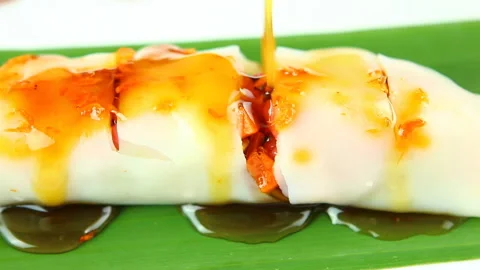Pouring sauce on fresh spring rolls , in door  Chiangmai Thailand Stock Footage 156373670