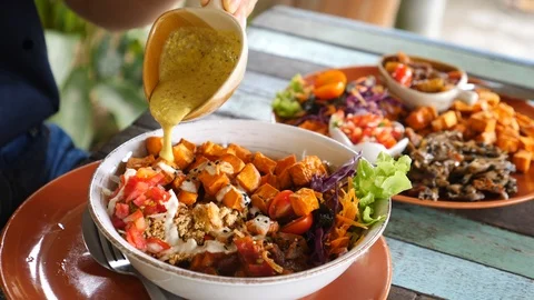 Pouring Sauce On Vegan Bowl With Sweet Potato And Vegetables. Healthy Food. Stock Footage