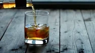 Pouring A Scotch Whiskey Into Glass With Ice Stock Footage