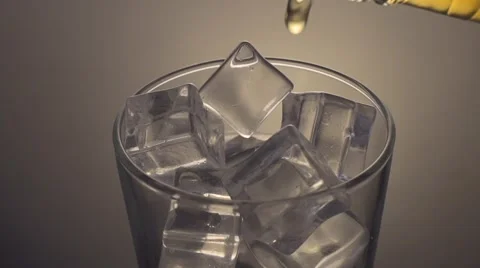 Pouring scotch whiskey over ice, close up Stock Footage 55846489