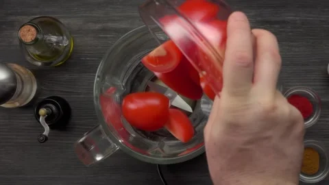 Pouring Sliced Tomatoes into a Blender, Top View Stock Footage 328095067