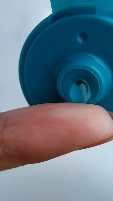 Pouring a small amount of clear cream onto the fingertip. Close up view, sk.. Stock Footage 331255168
