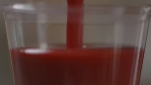 Pouring smoothie into a plastic cup Stock Footage 194478597