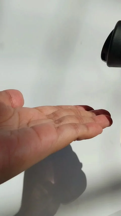 Pouring soap into hands. Vertical view with natural sunlight. Stock Footage 329787356