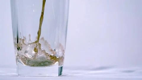 Pouring Soft Drink In A Long Drinking Glass On White Isolated Background Video stock 138553173