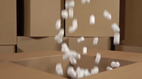 Pouring soft polystyrene pieces into big carton. Shockproof packaging material Stock Footage 67675485