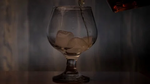 Pouring some brandy into a glass Stock Footage 129973040