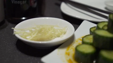 Pouring soy sauce onto ginger. Slow motion.  Video stock 78886409