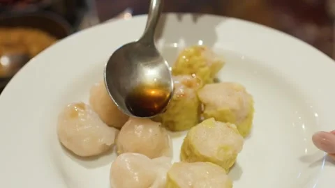 Pouring Soy Sauce Over Fresh Steamed Dim Sum Dumplings on Plate Stock Footage 333301253