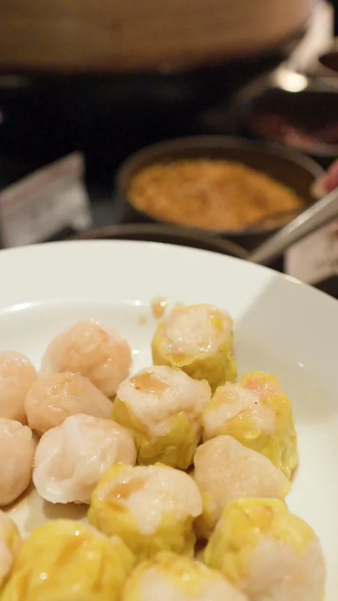 Pouring Soy Sauce Over Steamed Shumai and Har Gow Dim Sum Dumplings Stock Footage 333604848