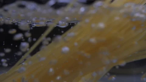 Pouring spaghetti pasta into pot with boiling water slow motion Video stock 149718569
