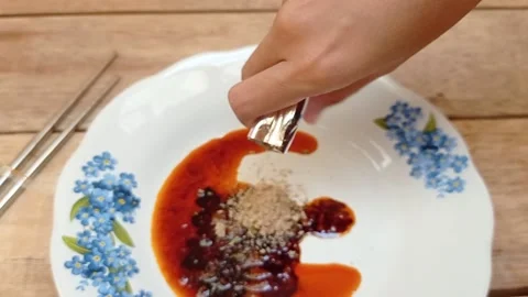 Pouring a spices into a plate Stock Footage 145377687