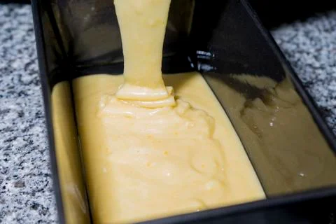  Pouring sponge cake dough into a rectangular corner Stock Photos