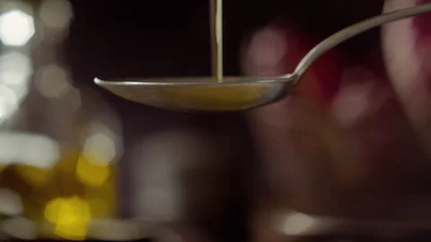 Pouring a spoon of olive oil Stock Footage 135012003