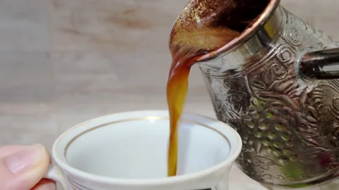 Pouring a steaming cup of Coffee into a finely crafted Fine China Cup, enhancing Stock Footage 301446467