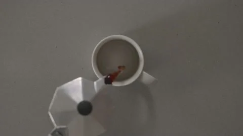 Pouring a steaming hot cup of fresh brewed espresso coffee, from a birds 스톡 동영상 132397176
