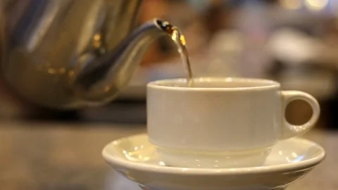Pouring steaming hot tea into cup. Waiting someone in a restaurant. Stock Footage 93011644
