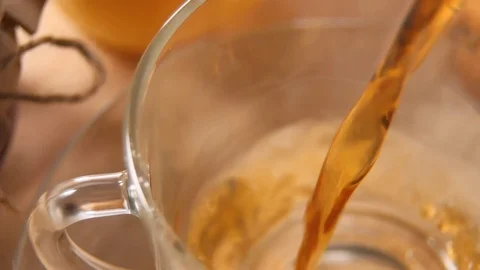 Pouring steaming tea in a tea cup from teapot, view from above Stock-Footage 104027639