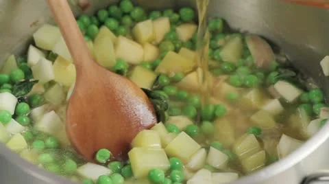 Pouring stock into pea soup Stock Footage 24665877