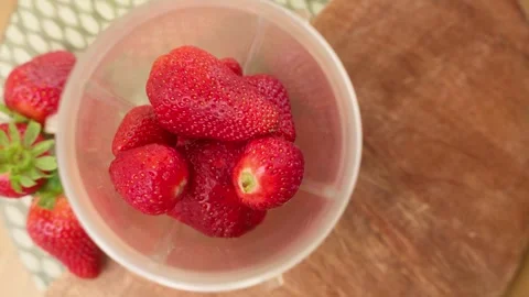 Pouring Strawberries into Blender and Serving Smoothie Stock Footage 306752626