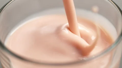 Pouring strawberry smoothie in slow motion. Stock Footage 162851223