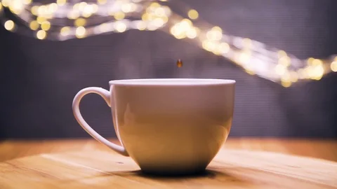 Pouring stream coffee into a cup of espresso, super slow motion. Stock Footage 128700126