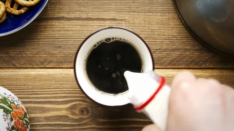 Pouring stream milk from bottle to the cup of americano 動画素材 106141505