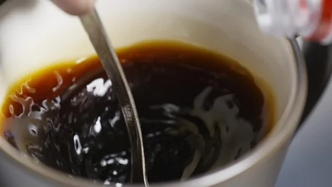 Pouring stream milk into cup of coffee Stock Footage 105502548