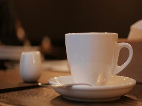 Pouring stream milk into a cup of espresso Stock Footage 82201749