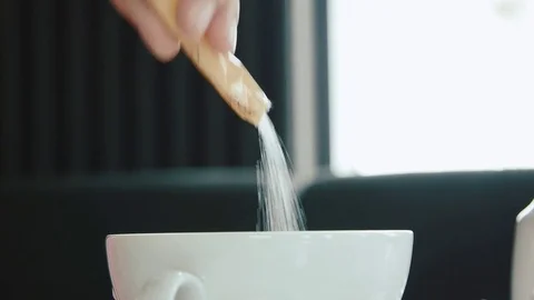 Pouring sugar into a cup Stock Footage 76926820