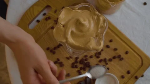 Pouring sugar on Dalgona coffee Stock Footage 131077363
