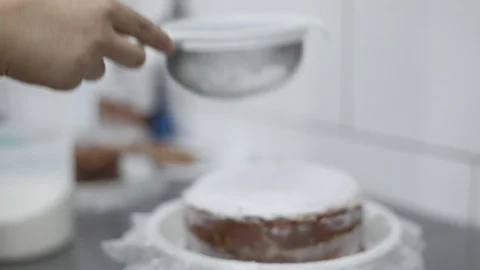 Pouring Sugar on a Dulce de Leche Cake Stock Footage 128820544