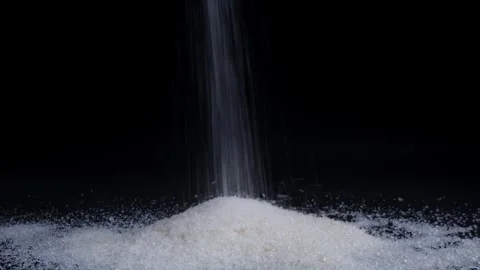 Pouring sugar isolated on black background Stock Footage 281635938