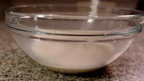 Pouring sugar in the milk slow motion Stock Footage