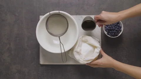 Pouring sugar into a sieve 스톡 동영상 124585063