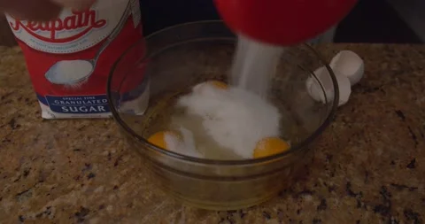 Pouring sugar a top of eggs Stock Footage 147259463