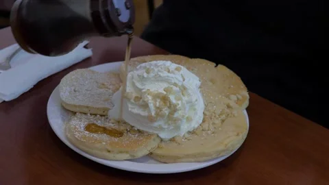 Pouring Syrup Over Macadamia Nut Pancakes In Waikiki, Honolulu, Hawaii Stock Footage 154294249
